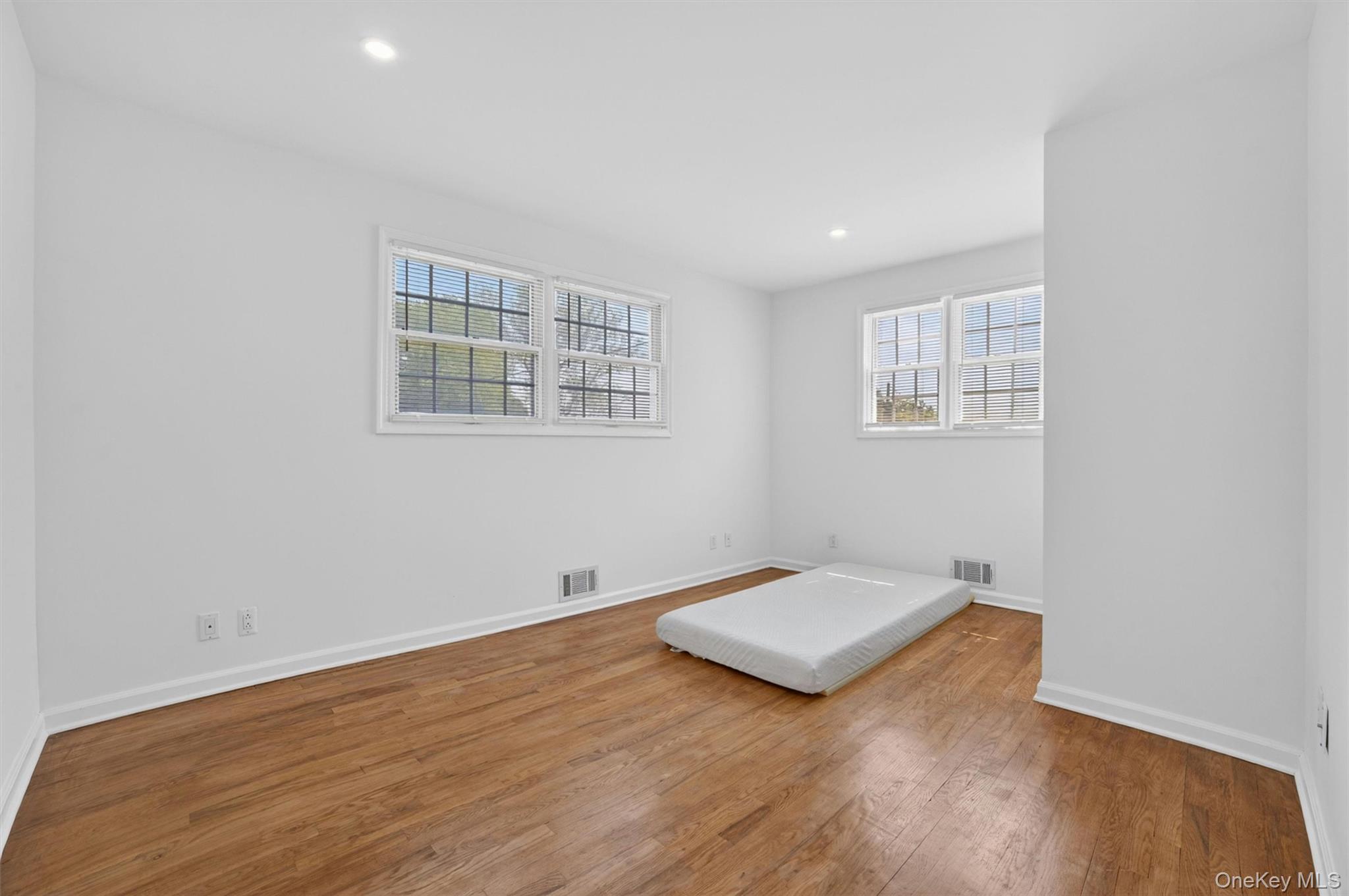 263 Croydon Road Yonkers, NY 10710 - Photo 13 of 43 an empty room with wooden floor and windows