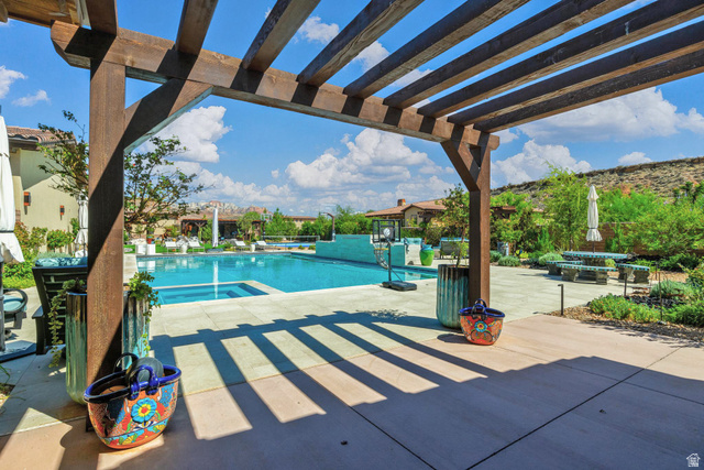 168 South Rancho Santa Fe Virgin, UT 84779 - Photo 53 of 68 Expansive outdoor living area featuring a large swimming pool, integrated spa, paved patio, and a wood pergola