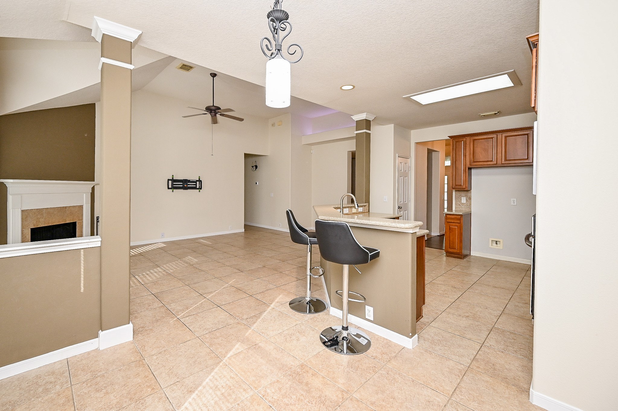 2726 Redwick Drive Spring, TX 77388 - Photo 11 of 32 a view of a kitchen with kitchen island granite countertop wooden floor and chairs