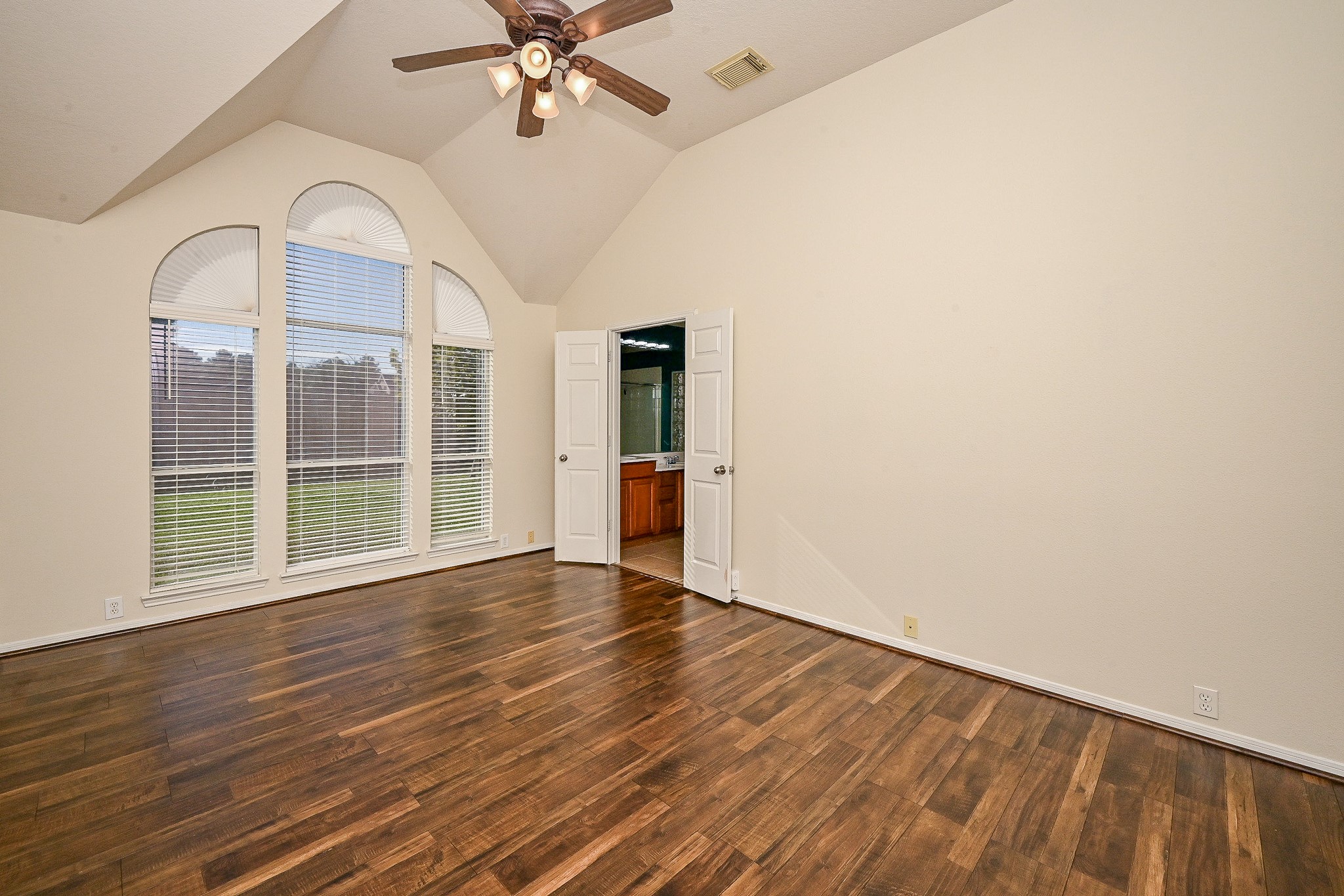 2726 Redwick Drive Spring, TX 77388 - Photo 22 of 32 an empty room with wooden floor fan and windows
