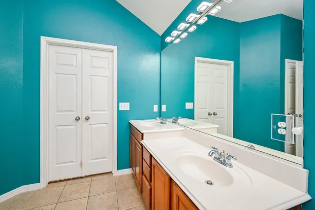 a bathroom with a sink vanity and a mirror