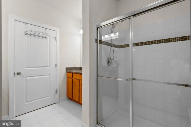 a bathroom with a shower and a glass door