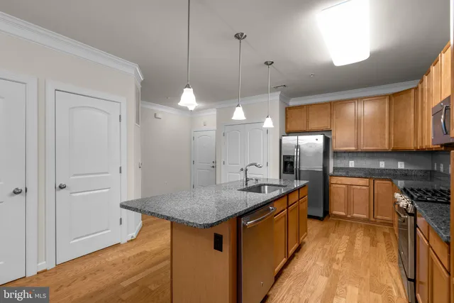 a kitchen with refrigerator and cabinets