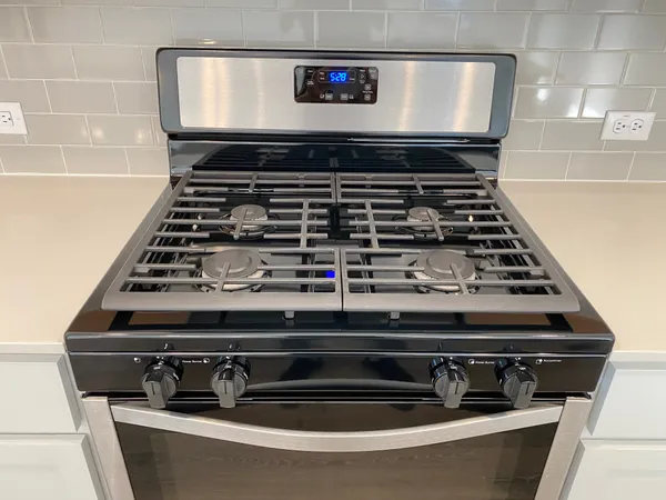 a view of an empty room with wooden floor and a ceiling fan