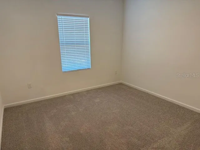 a kitchen with a sink a microwave a refrigerator and cabinets