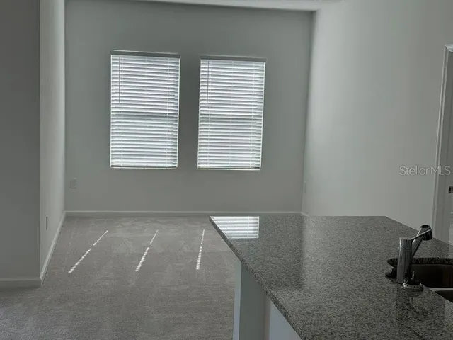 a kitchen with a refrigerator a microwave and sink