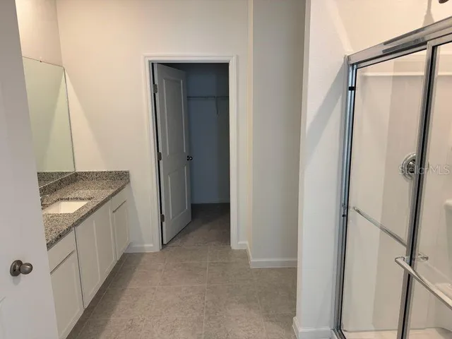 a bathroom with a glass door shower