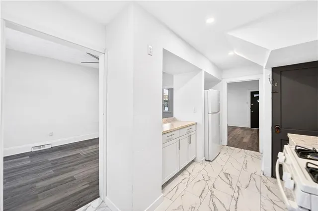 a spacious bedroom with a bed and a flat screen tv