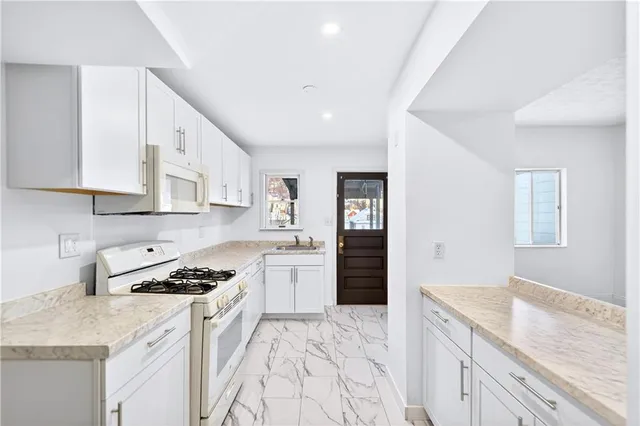 a kitchen with a stove cabinets and a wooden floor
