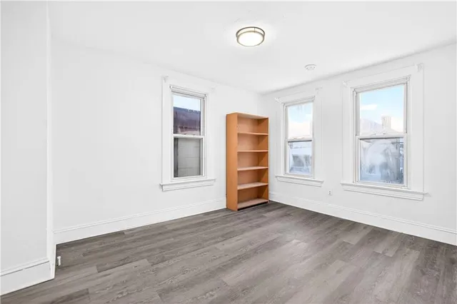 a view of a room with wooden floor