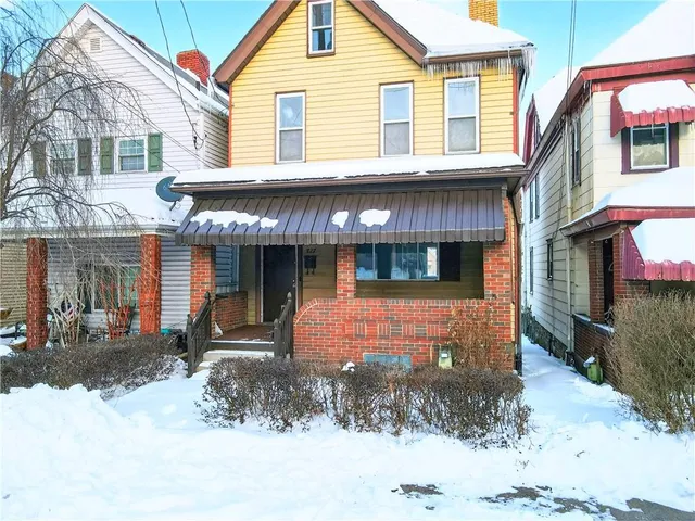 a view of an empty room with large windows