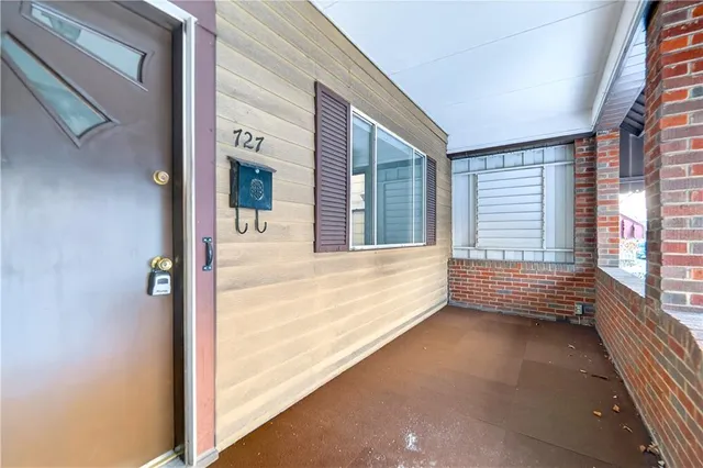 a view of a house with a porch and furniture