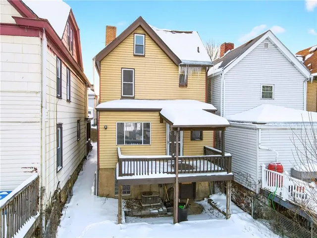 a row of houses with yard and mountain view in back