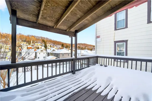 a view of a house with a yard and wooden fence
