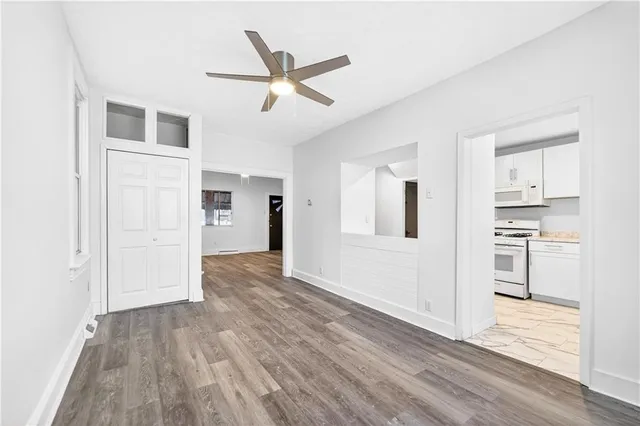 a view of a hallway with wooden floor and closet