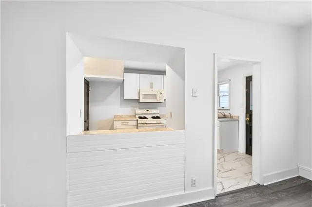 a kitchen with white cabinets and refrigerator