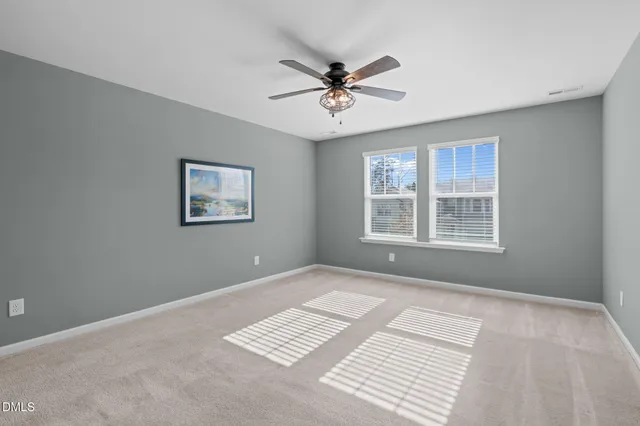 an empty room with closet and windows