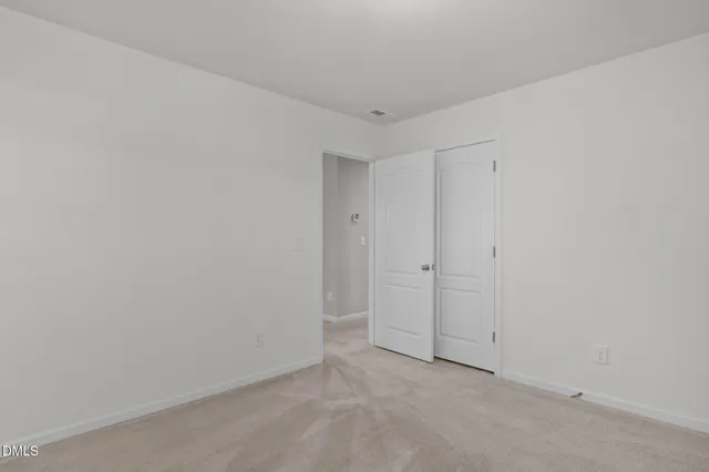 a bathroom with a shower a mirror and a sink