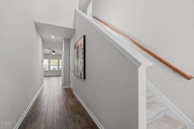 a view of hallway with wooden floor