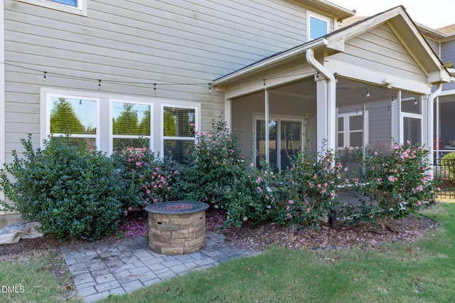 a view of a porch with furniture and a yard