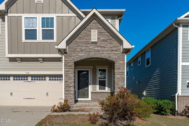 a front view of a house with a garden and porch