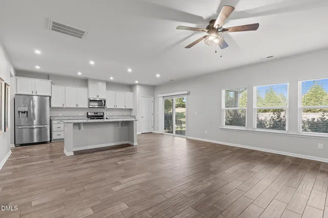an aerial view of a house with a garden and lake view