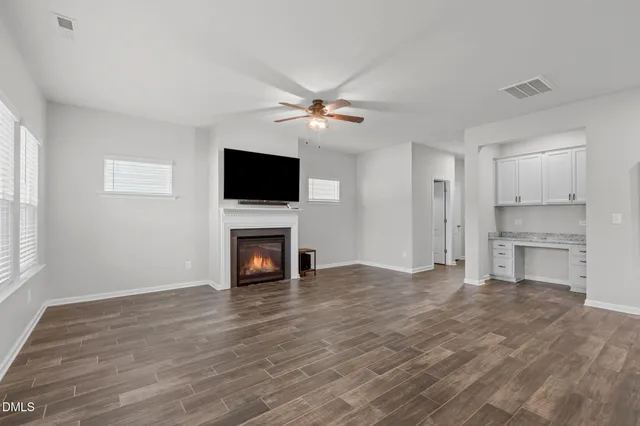 a view of kitchen with refrigerator stove and wooden floor