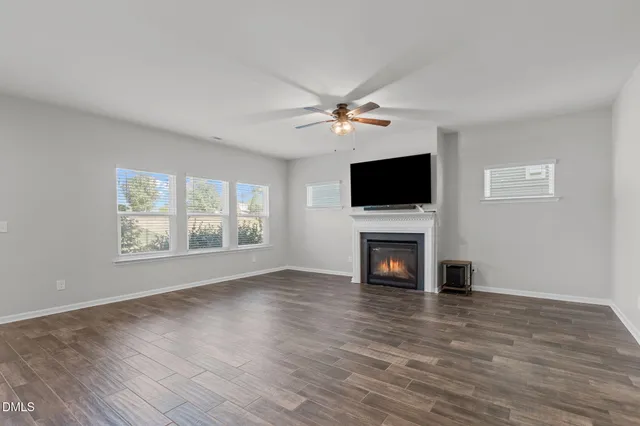 a view of kitchen with stove and cabinets