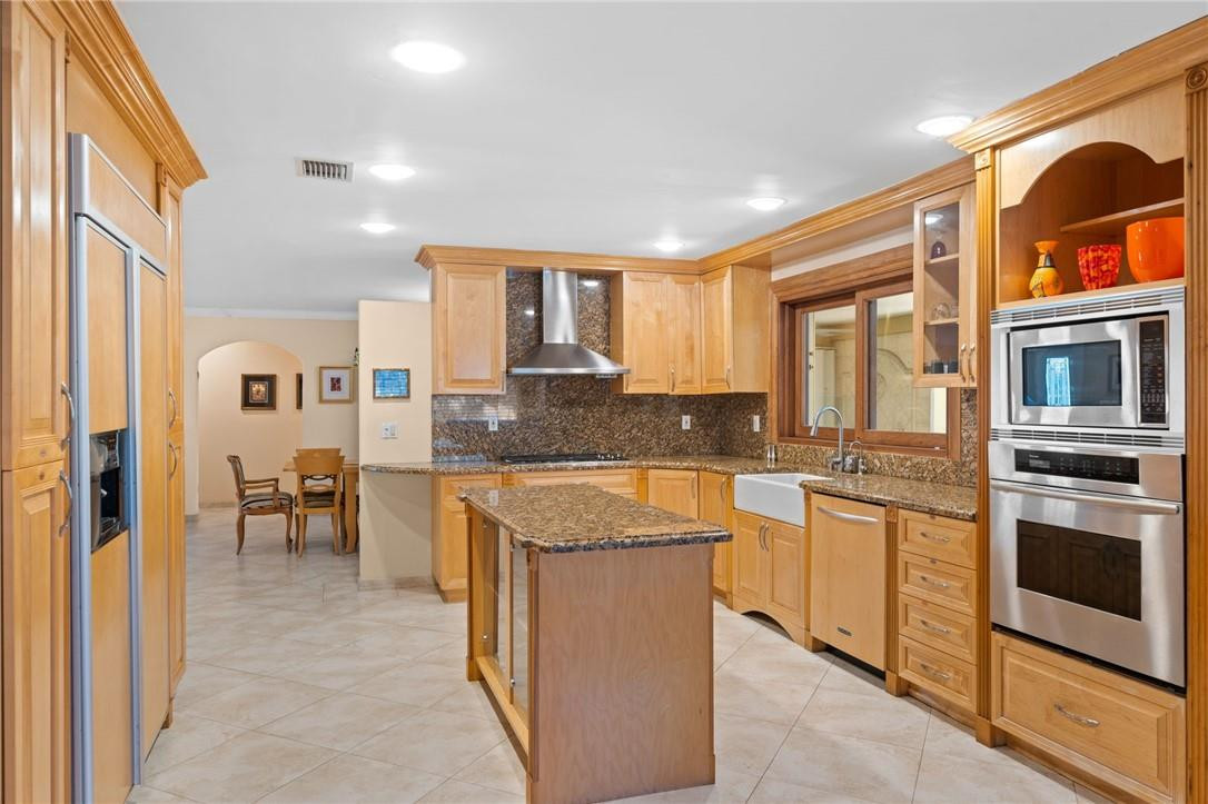 3800 North Park Road Hollywood, FL 33021 - Photo 11 of 27 a large kitchen with stainless steel appliances granite countertop a stove and a sink