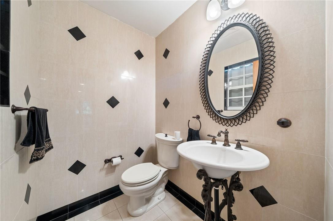 3800 North Park Road Hollywood, FL 33021 - Photo 16 of 27 a bathroom with a sink a toilet and a mirror