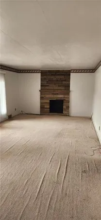 a view of an empty room with a fireplace