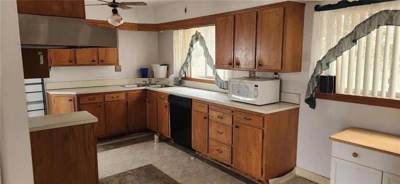 25 Kay Street Uniontown, PA 15401 - Photo 4 of 9 a kitchen with stainless steel appliances granite countertop a sink stove and cabinets