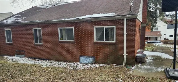 a view of a brick house with many windows