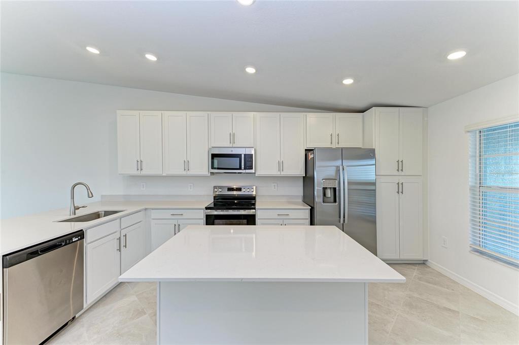 19015 Scallop Loop, Unit 7121 Lakewood Ranch, FL 34211 - Photo 20 of 48 a kitchen with stainless steel appliances a refrigerator sink and microwave