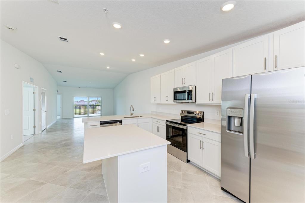 19015 Scallop Loop, Unit 7121 Lakewood Ranch, FL 34211 - Photo 21 of 48 a kitchen with cabinets and stainless steel appliances
