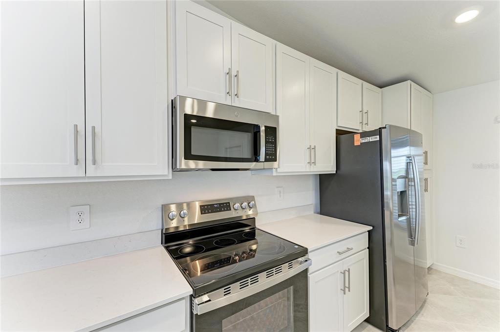 19015 Scallop Loop, Unit 7121 Lakewood Ranch, FL 34211 - Photo 24 of 48 a kitchen with a refrigerator stove and microwave