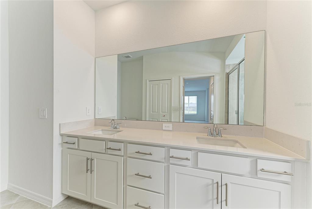 19015 Scallop Loop, Unit 7121 Lakewood Ranch, FL 34211 - Photo 30 of 48 a bathroom with a sink and a mirror