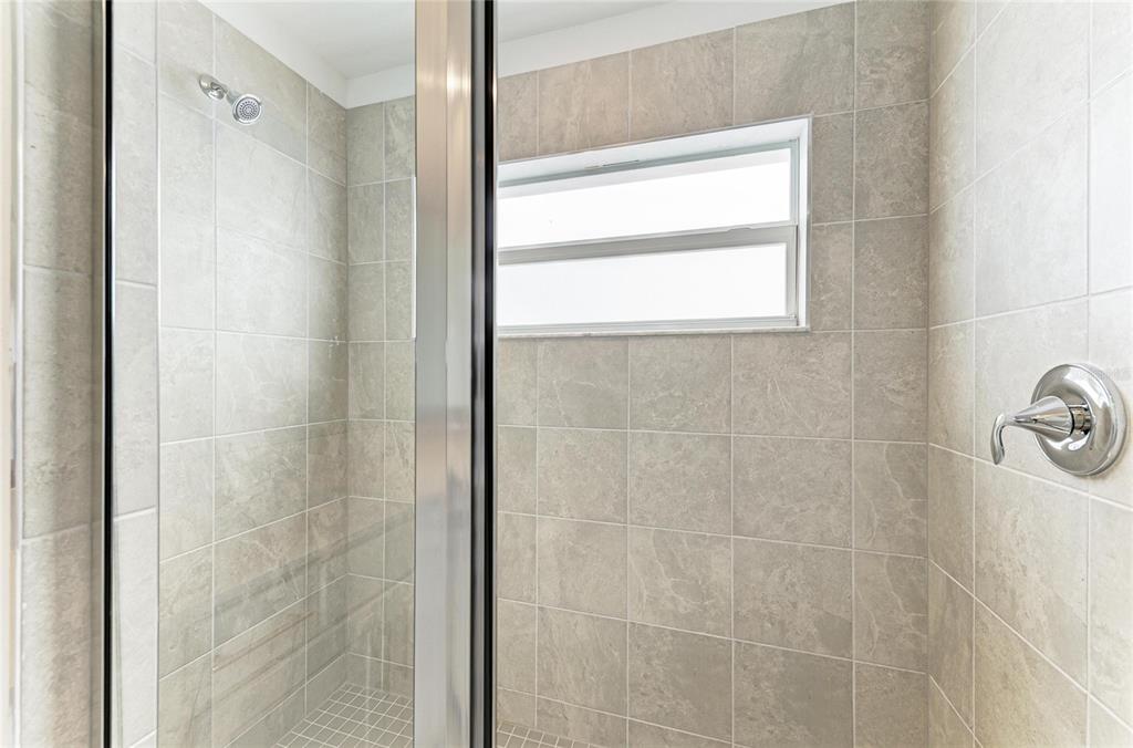 19015 Scallop Loop, Unit 7121 Lakewood Ranch, FL 34211 - Photo 31 of 48 a bathroom with a window and a shower