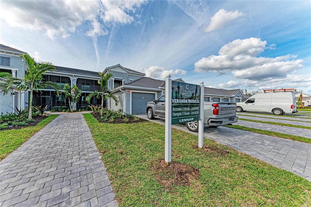 19015 Scallop Loop, Unit 7121 Lakewood Ranch, FL 34211 - Photo 47 of 48 a front view of a house with a yard table and chairs