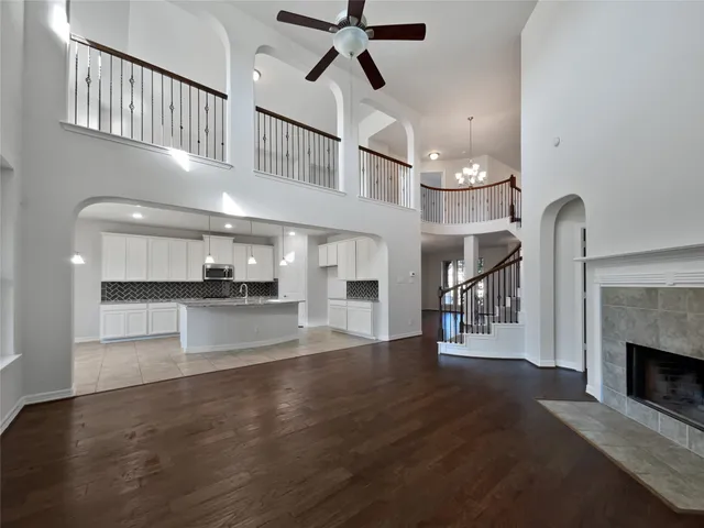 a view of empty room with kitchen view and a fireplace