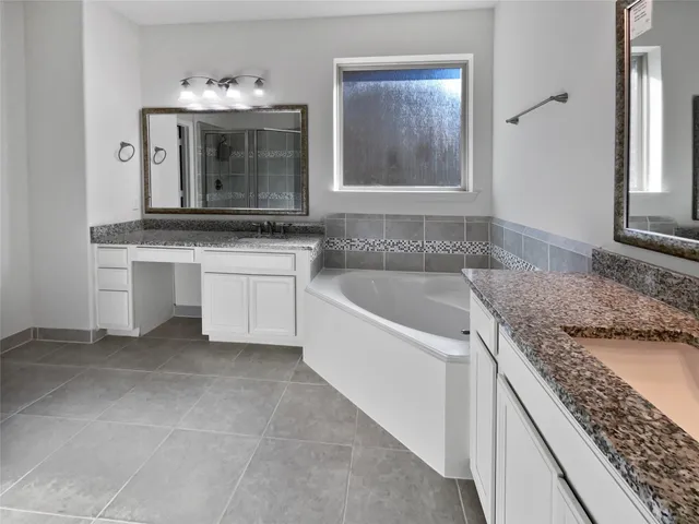 a bathroom with a granite countertop sink and mirror
