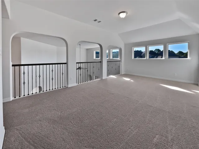 a view of an empty room with windows