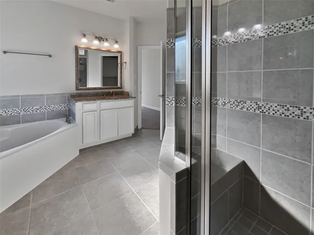 a bathroom with a bathtub sink and mirror