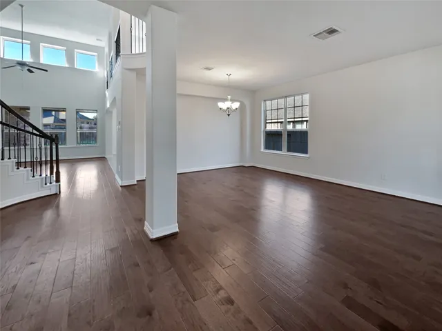 a view of a room with wooden floor and a window