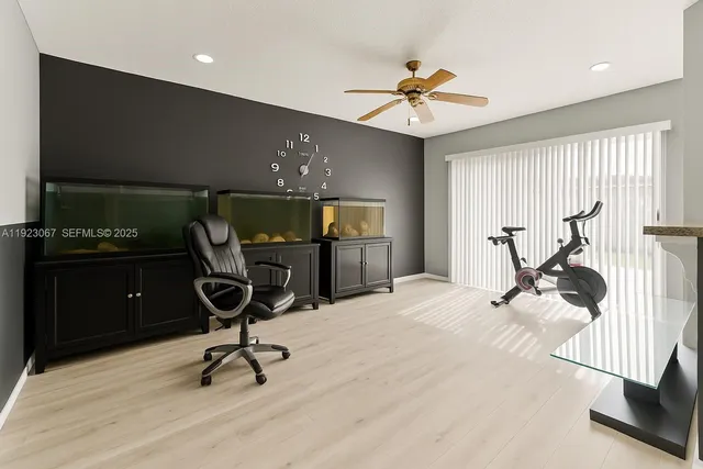 a view of a workspace with furniture and a window