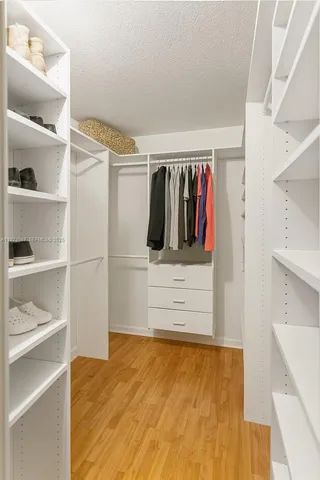 a view of walk in closet with empty racks