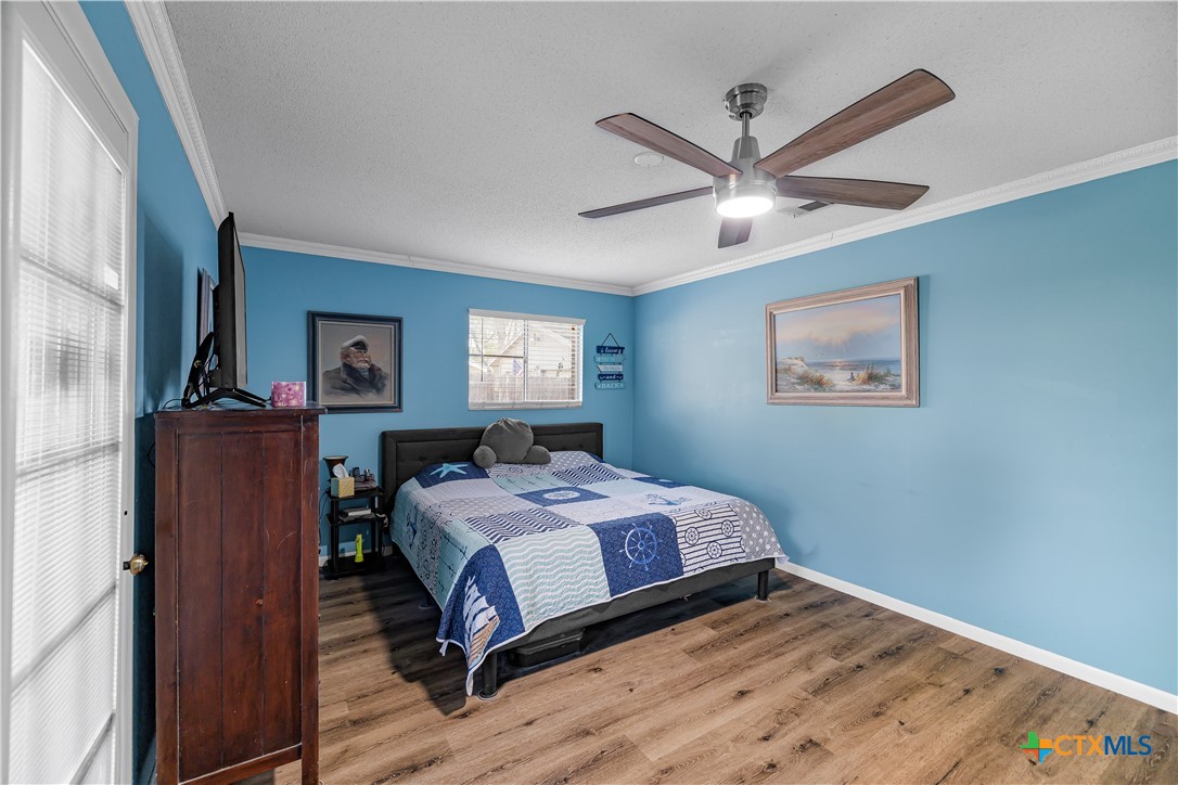 204 Brooks Road Victoria, TX 77904 - Photo 15 of 22 a bedroom with a bed and a chandelier