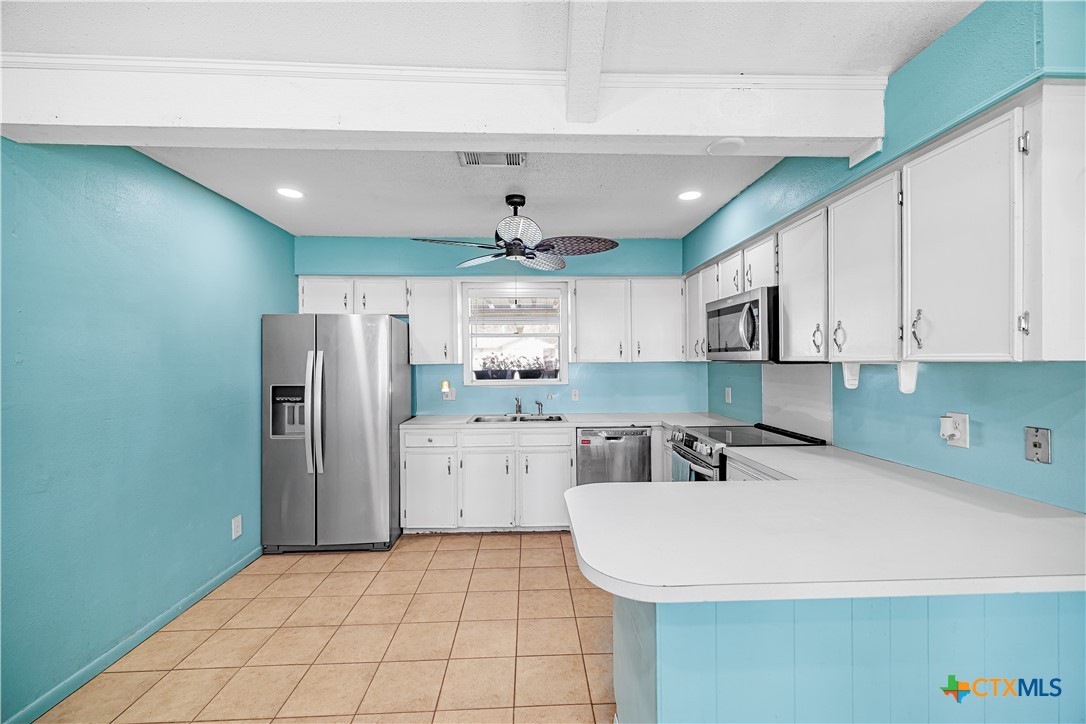 204 Brooks Road Victoria, TX 77904 - Photo 5 of 22 a kitchen with a refrigerator a sink and cabinets