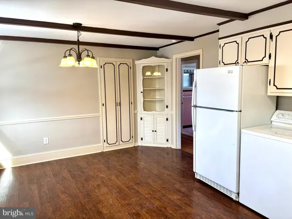 a view of a refrigerator with wooden floor