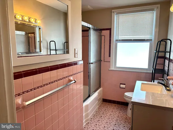 a bathroom with a sink a mirror and a toilet